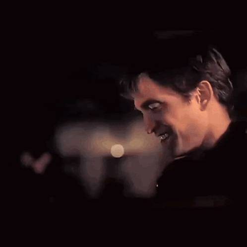 A Close Up Of A Man 'S Face With A Blurred Background GIF