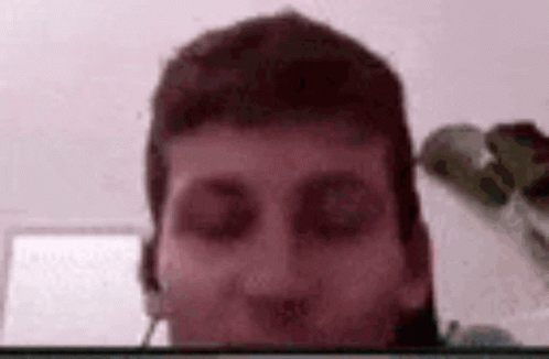 A Close Up Of A Man 'S Face With A Blurred Background . GIF