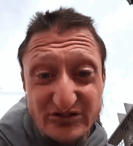 A Close Up Of A Man 'S Face With A Blurred Background That Says ' Larsonrecorder ' On It GIF