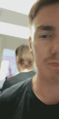 A Close Up Of A Man 'S Face With A Blurry Background GIF