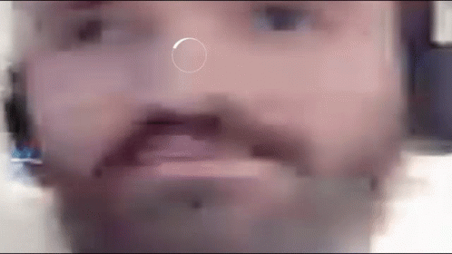 A Close Up Of A Man 'S Face With A Circle In The Middle Of His Nose . GIF