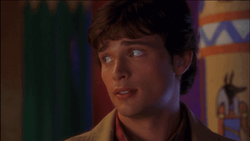 A Close Up Of A Man 'S Face With A Colorful Background Behind Him GIF