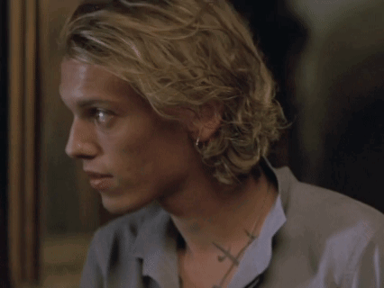 A Close Up Of A Man 'S Face With A Cross Tattoo On His Neck GIF