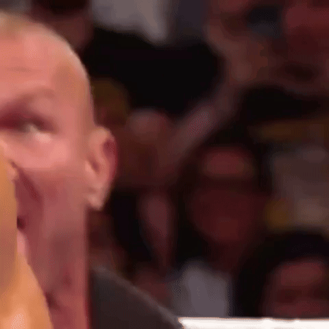 A Close Up Of A Man 'S Face With A Crowd Behind Him . GIF