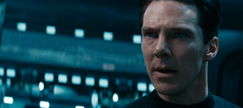 A Close Up Of A Man 'S Face With A Dark Background GIF