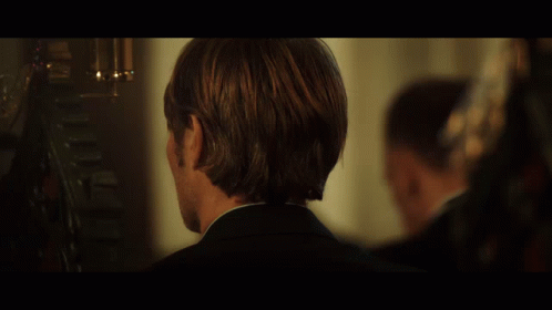 A Close Up Of A Man 'S Face With A Dark Background GIF