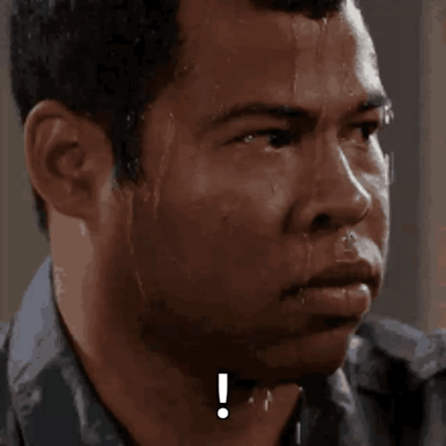 A Close Up Of A Man 'S Face With A Exclamation Point On His Forehead GIF