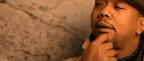 A Close Up Of A Man 'S Face With A Finger On His Chin . GIF