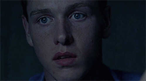 A Close Up Of A Man 'S Face With A Finger On His Mouth GIF