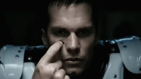 A Close Up Of A Man 'S Face With A Finger On His Nose . GIF