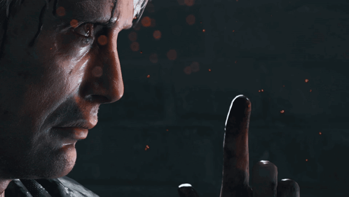 A Close Up Of A Man 'S Face With A Finger Pointing Up GIF