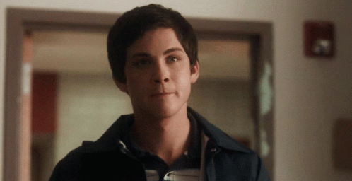 A Close Up Of A Man 'S Face With A Fire Extinguisher On The Wall GIF