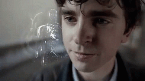 A Close Up Of A Man 'S Face With A Ghost In The Background Behind Him . GIF
