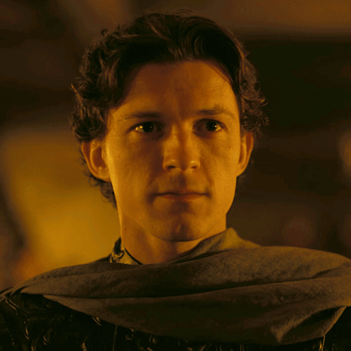 A Close Up Of A Man 'S Face With A Gray Scarf Around His Neck GIF