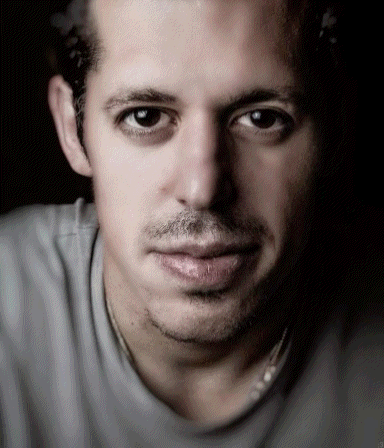 A Close Up Of A Man 'S Face With A Gray Shirt GIF