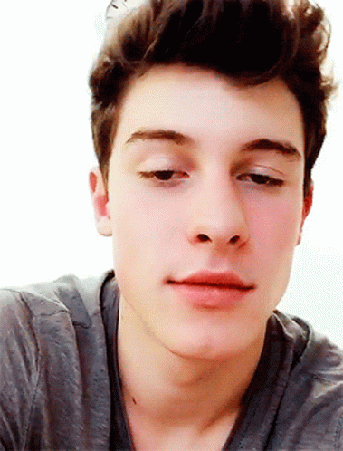 A Close Up Of A Man 'S Face With A Gray Shirt On GIF