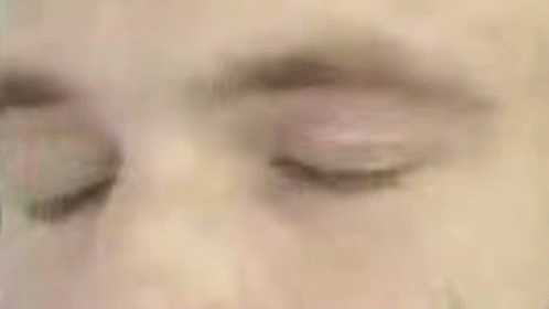 a close up of a man 's face with a green circle around his head