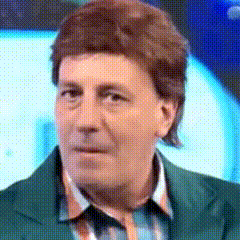 A Close Up Of A Man 'S Face With A Green Jacket On GIF