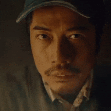 A Close Up Of A Man 'S Face With A Hat On And A Mustache . GIF