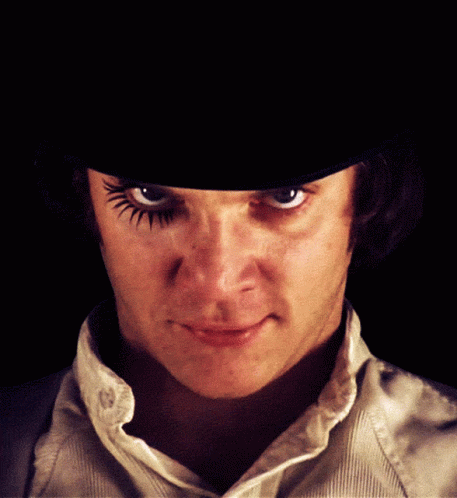 A Close Up Of A Man 'S Face With A Hat On GIF