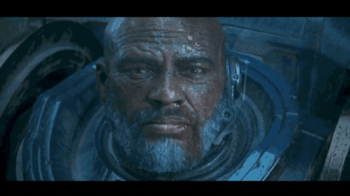 A Close Up Of A Man 'S Face With A Helmet On His Head GIF