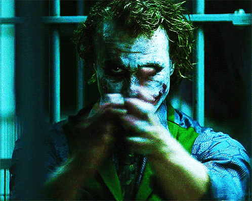 A Close Up Of A Man 'S Face With A Joker Face Paint GIF