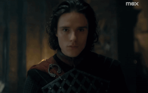 A Close Up Of A Man 'S Face With A Max Logo In The Background GIF