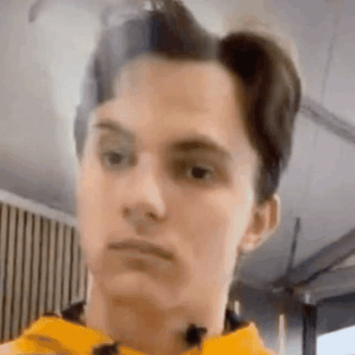 A Close Up Of A Man 'S Face With A Microphone In His Neck . GIF