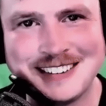 A Close Up Of A Man 'S Face With A Microphone On His Head . GIF