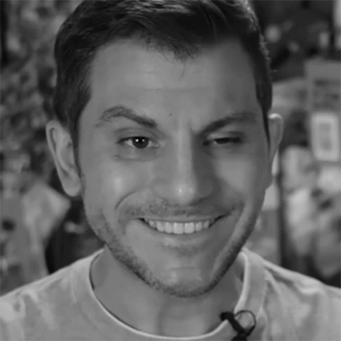 A Close Up Of A Man 'S Face With A Microphone On His Neck GIF