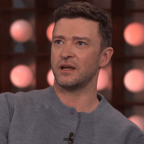 A Close Up Of A Man 'S Face With A Microphone On It GIF