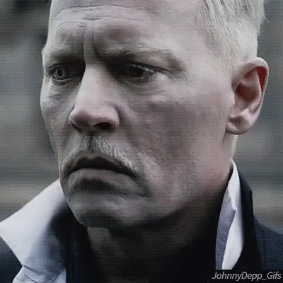 A Close Up Of A Man 'S Face With A Mustache And A White Shirt . GIF