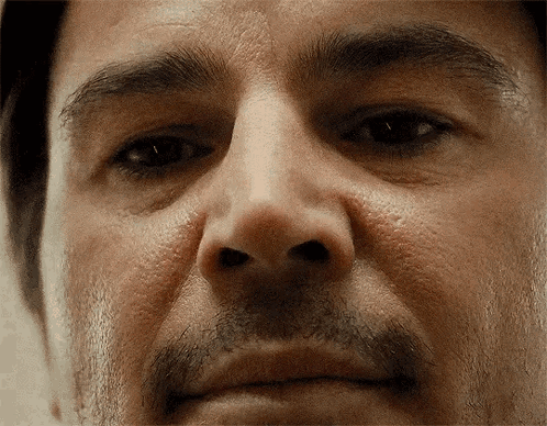 A Close Up Of A Man 'S Face With A Mustache And Eyebrows GIF