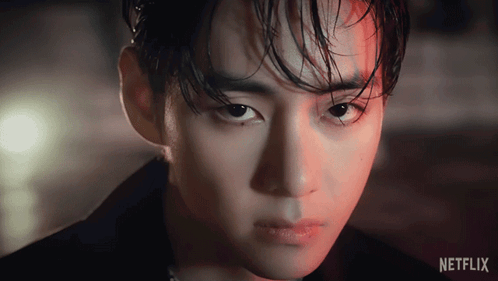A Close Up Of A Man 'S Face With A Netflix Logo Behind Him GIF