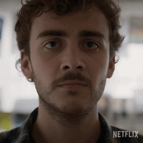 A Close Up Of A Man 'S Face With A Netflix Logo On The Bottom GIF