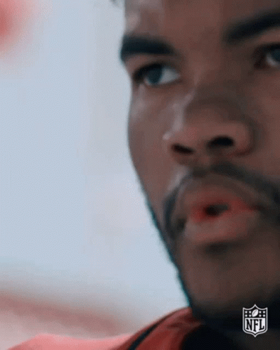 A Close Up Of A Man 'S Face With A Nfl Logo On The Bottom Right Corner . GIF