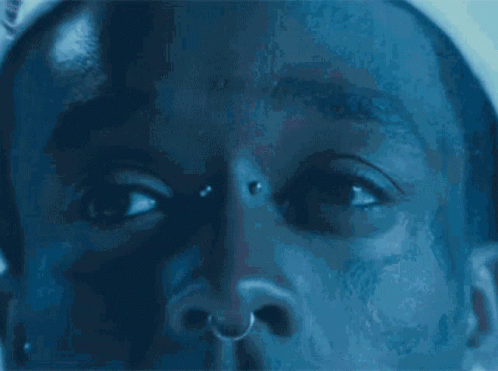 A Close Up Of A Man 'S Face With A Nose Ring GIF