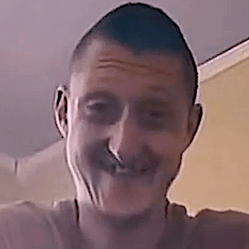 A Close Up Of A Man 'S Face With A Nose Ring On It GIF