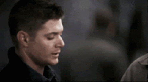 A Close Up Of A Man 'S Face With A Person Touching His Shoulder GIF