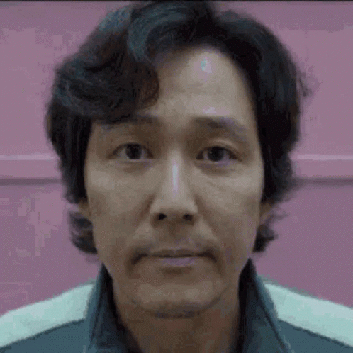 A Close Up Of A Man 'S Face With A Pink Background And A Beard . GIF