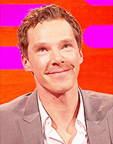 A Close Up Of A Man 'S Face With A Pink Background GIF