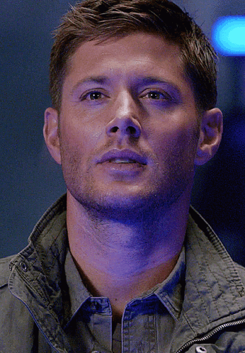 A Close Up Of A Man 'S Face With A Purple Background GIF