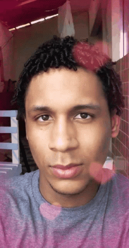 A Close Up Of A Man 'S Face With A Purple Shirt On GIF