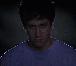 A Close Up Of A Man 'S Face With A Purple Shirt On GIF