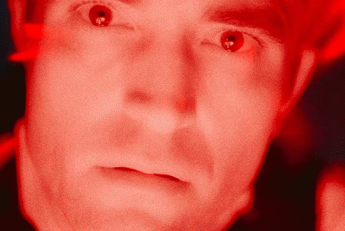 A Close Up Of A Man 'S Face With A Red Background GIF