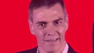 a close up of a man 's face with a red background and a smile on his face .