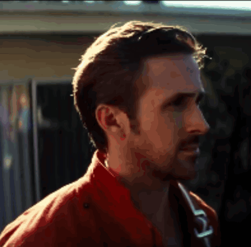 A Close Up Of A Man 'S Face With A Red Jacket On GIF