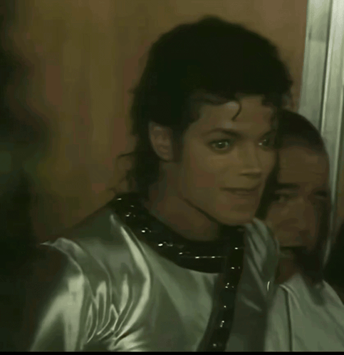 A Close Up Of A Man 'S Face With A Reflection In The Mirror GIF