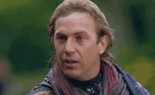 A Close Up Of A Man 'S Face With A Scarf Around His Neck . GIF