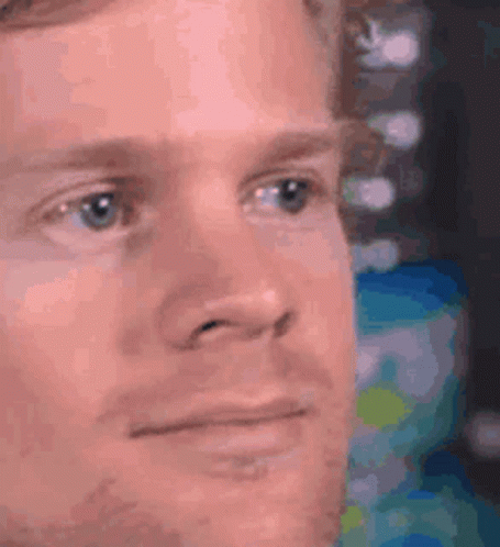 A Close Up Of A Man 'S Face With A Serious Expression On His Face . GIF